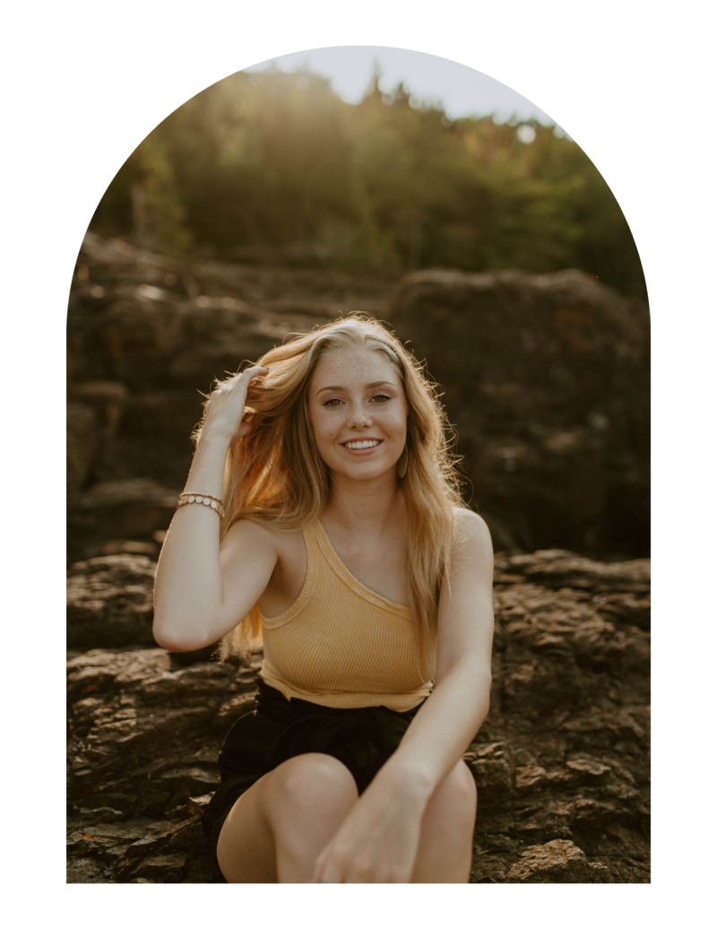 senior girl sitting on steps smiling