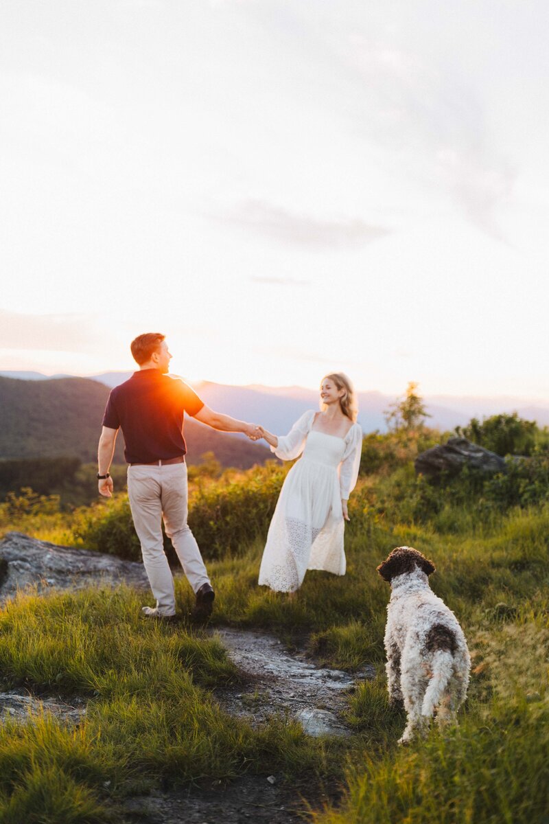 couple and dog enjoying an engagement session out in the blue ridge mountains