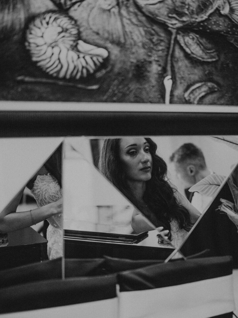 A black and white portrait of a bride, with angular geometric shapes and overlapping triangular forms, creates a dynamic composition 