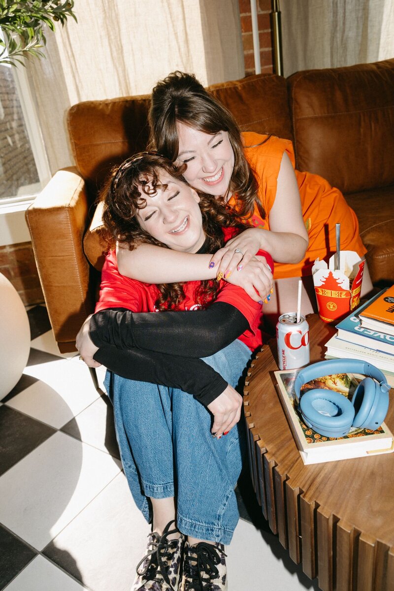 A woman sitting on a couch holding a disco ball.