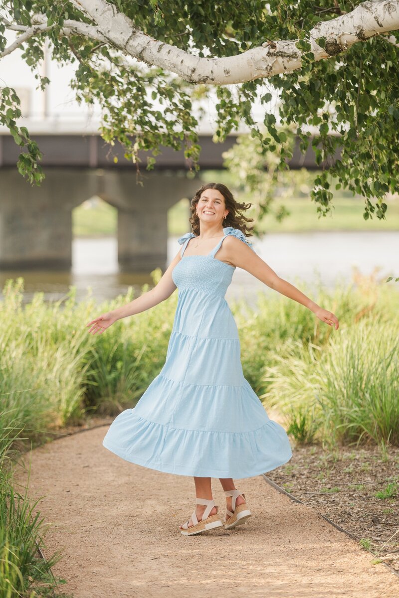 a girl twirling in a blue dress