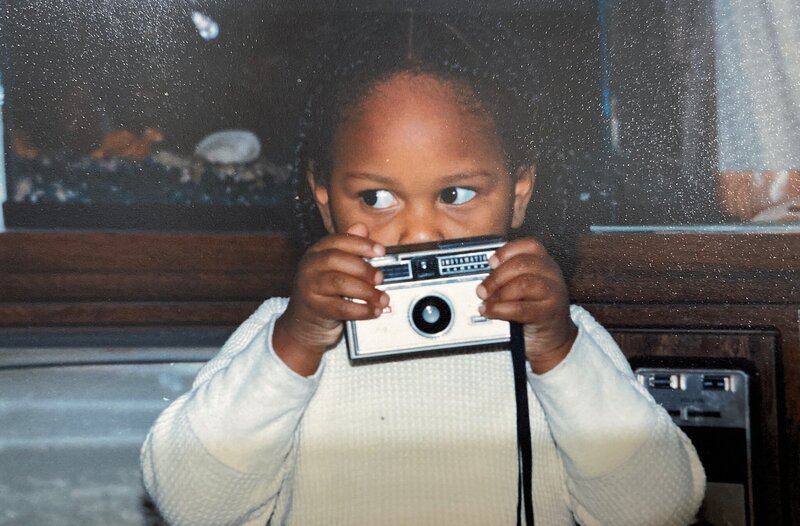 1970's image of black child with camera in her hands