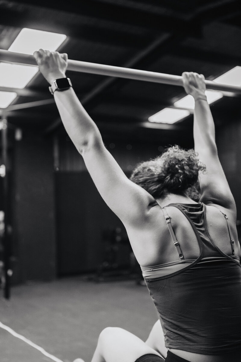 Women holding onto exercise bar. 