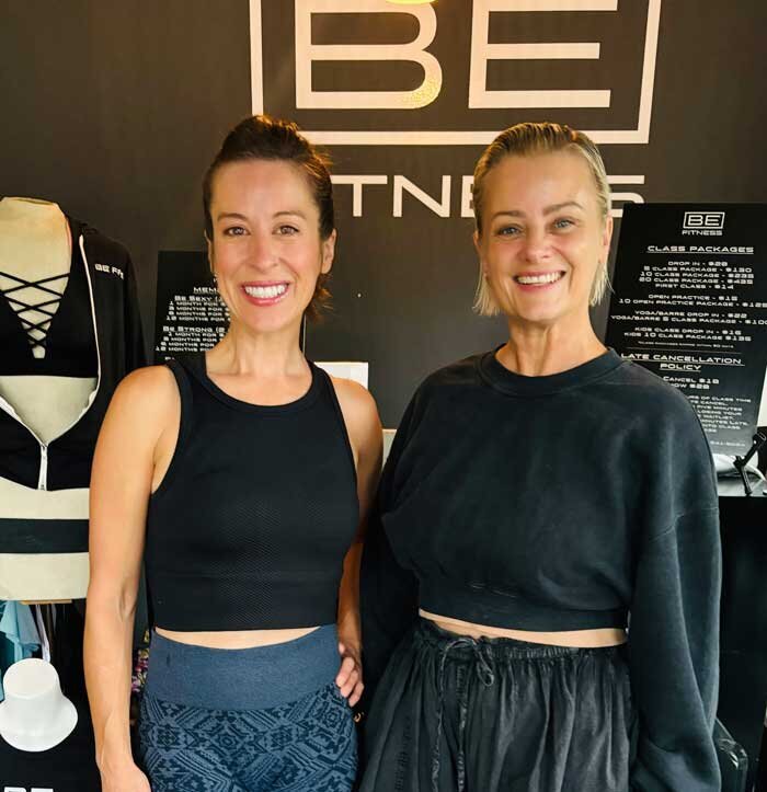 two woman standing at a yoga studio