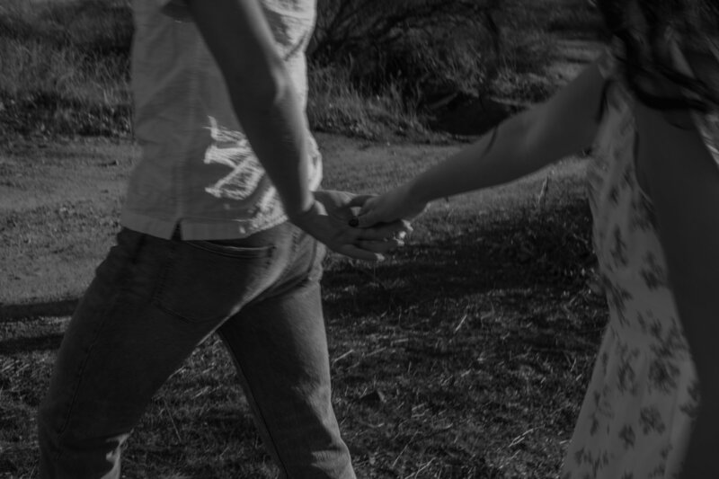 David holding Elizabeth's hand leading her forward, in black and white.