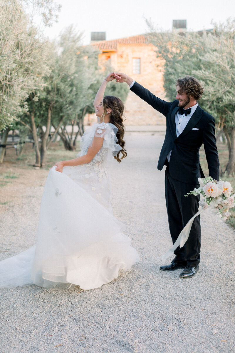 wedding-couple-dancing-olive-grove-cheerful-gesture