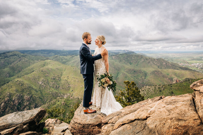 Boulder Wedding Photographer captures bride and groom on boulder during portraits
