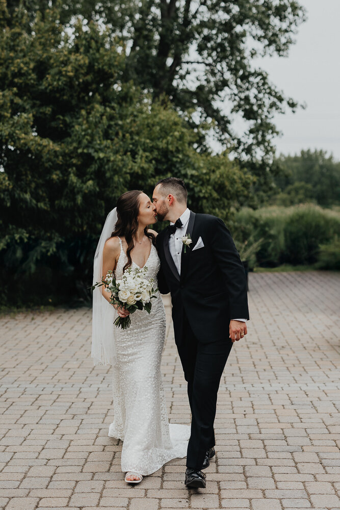 groom dancing with bride in a field