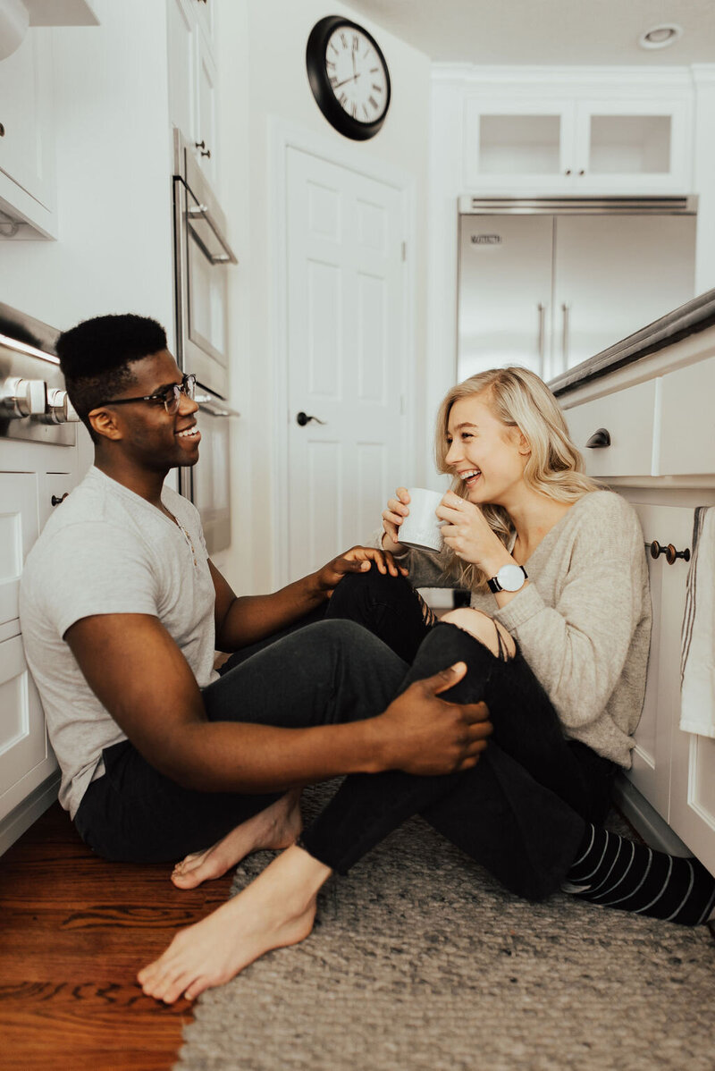 Couple sitting and lying on the floor in their living room