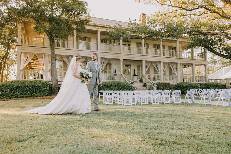 Bride and groom holding hands in front of their wedding venue in Gulf Shores, Alabama