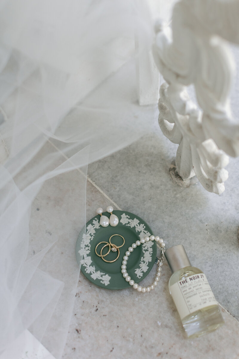 Bridal perfume bottle and diamond jewelry captured in romantic flat lay – Atlantic Beach wedding.