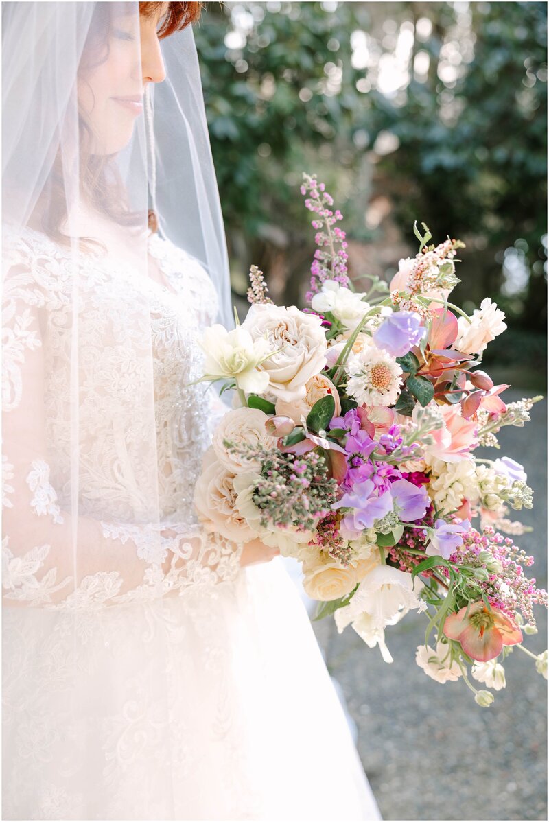 Bride and groom holding hands and walking through bridal party