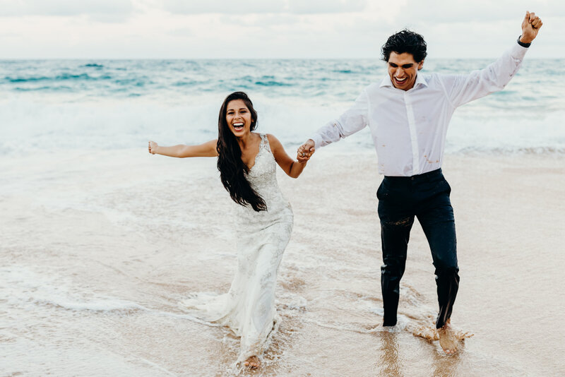 man holding woman hand on beach