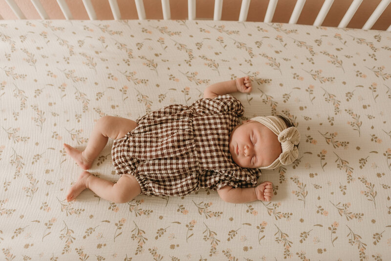 baby girl laying in  her crib for session in Monrovia, California