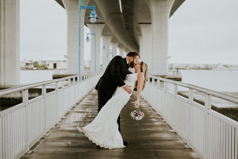 Couple does a dip kiss under the Roosevelt Bridge for their Stuart FL elopement