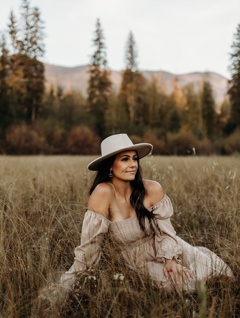 photographer posing for her headshots with grand mountain views in the background