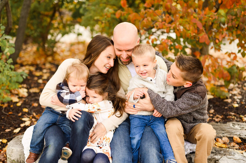 Large family embracing during a relaxed session at Kimball Hill Park by photographer near Chicago, IL.