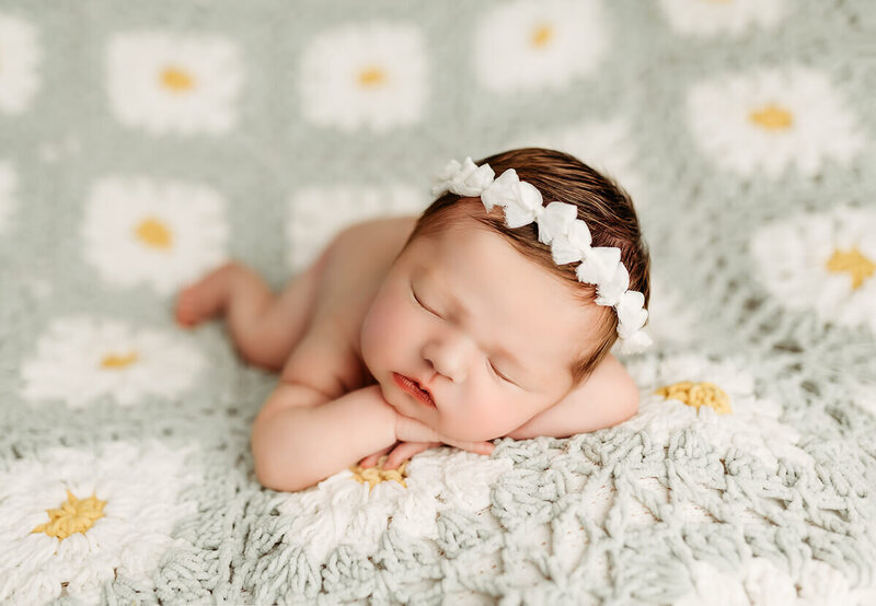 Airy newborn photograph with gentle highlights, minimal styling, and soft neutrals for a modern fine-art look.