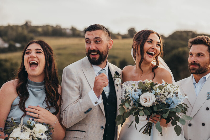 wedding party all laugh together