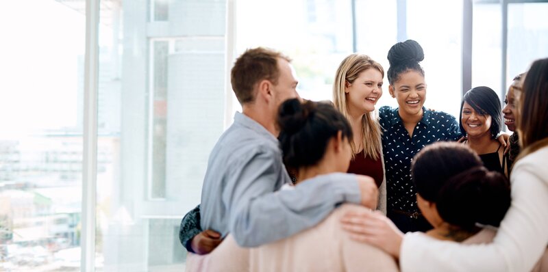 Group of women sharing a joyful moment in a welcoming environment.