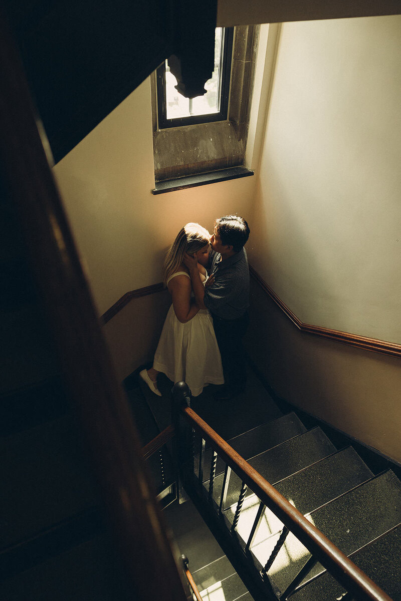 couple kissing on staircase