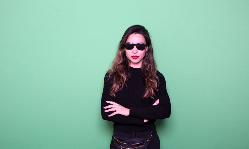 woman posing front of a green screen