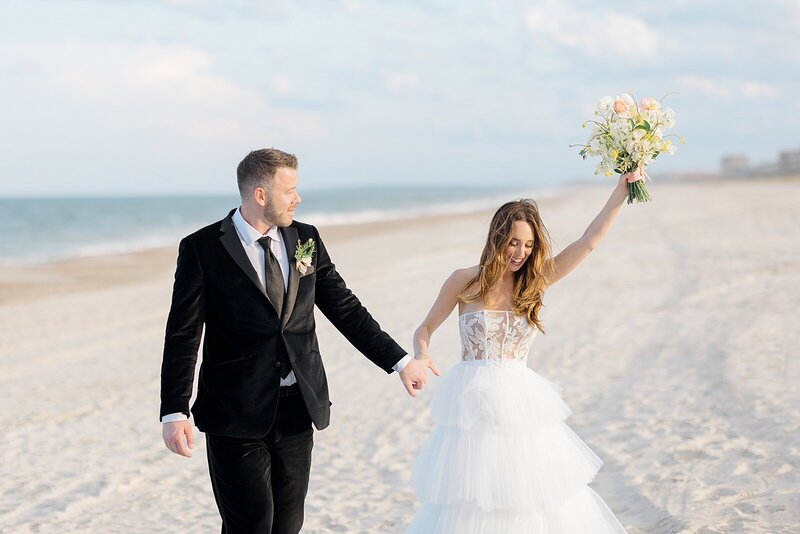 Beach wedding in Florida, with a bride in a ballgown holding a bouquet