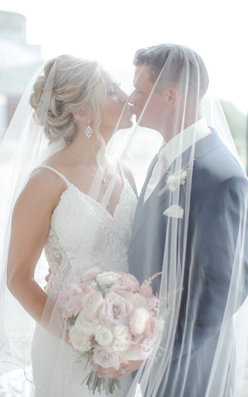 Bride and groom under a veil for bridal portraits in Palm Coast FL