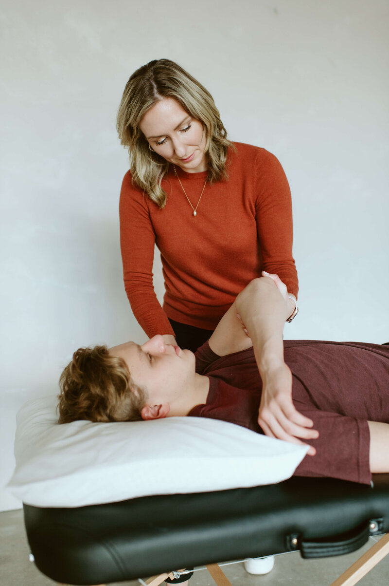 Dr. Gwen providing treatment for shoulder injury