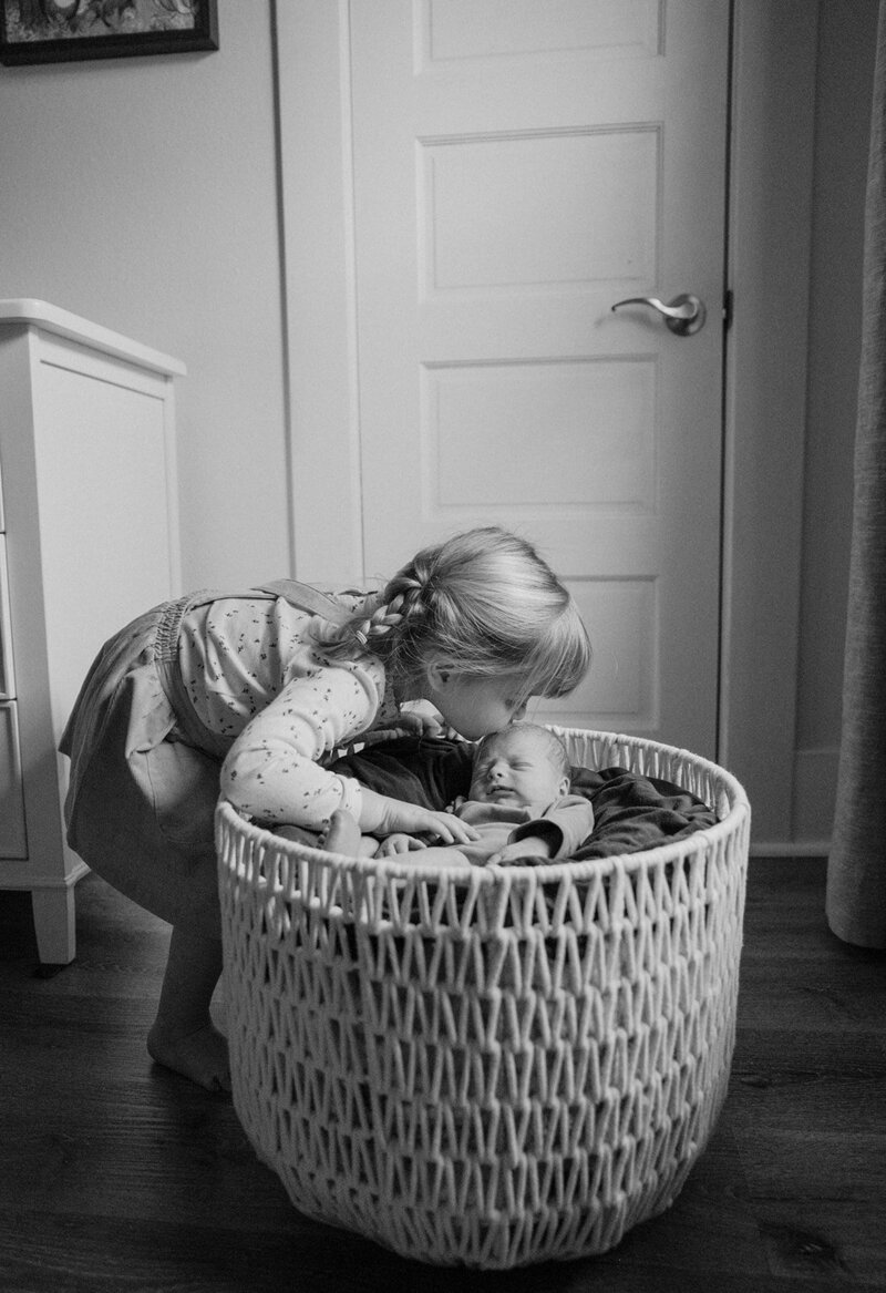 Child kissing newborn