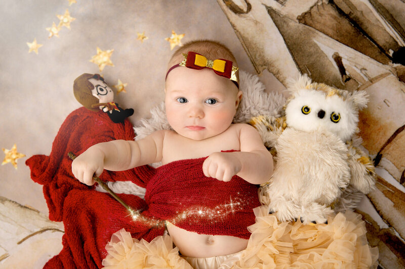 baby girl poses in a Harry Potter inspired milestone photoshoot