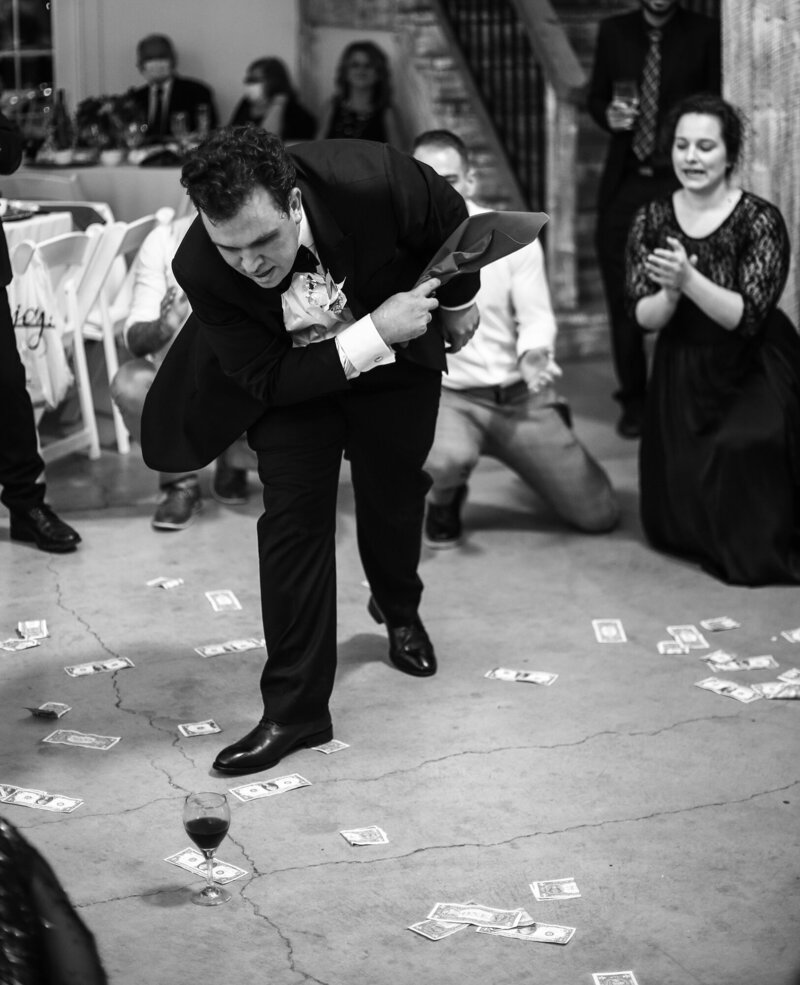 Groom doing traditional Greek wedding dance during Quincy Cellars wedding reception