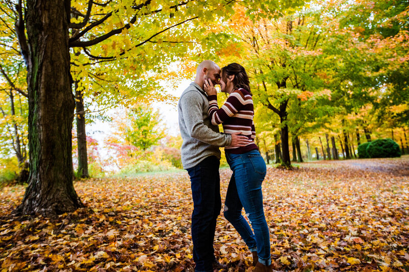 Couple embraces for engagement photos at Lake Erie Community Park in Girard PA