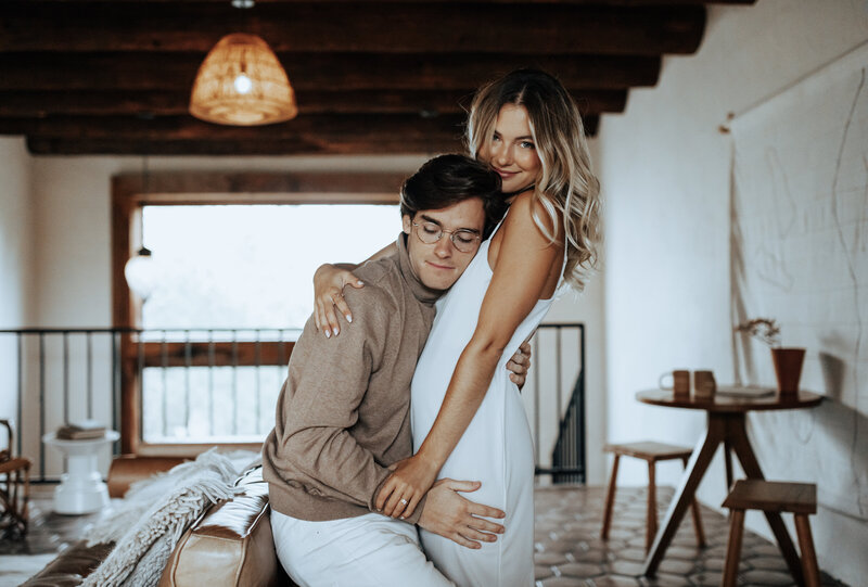 couple holding each other in living room