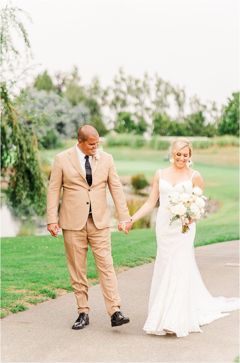 bride and groom walking down pathway at portland wedding venue  by wedding photographer 