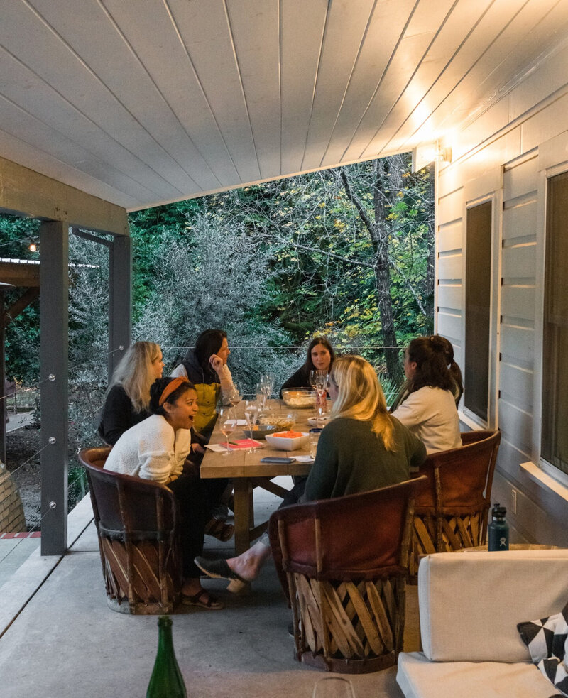 Girls Club mastermind retreat participants talking over happy hour in Guerneville