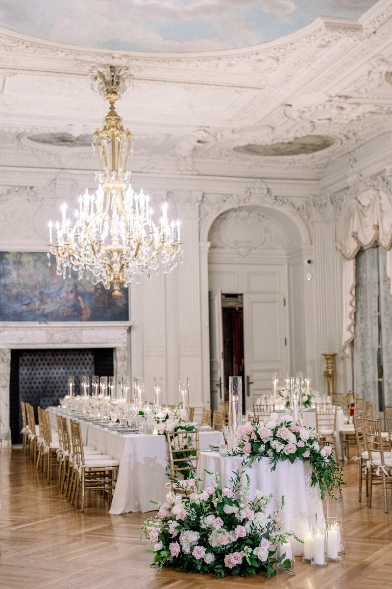 Rosecliff mansion in Newport rhode Island ballroom with lush flowers and candle lighting