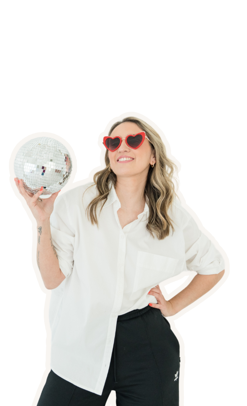 Small business website design expert dressed in branded outfit, holding a disco ball to represent confidence and a powerful attitude.