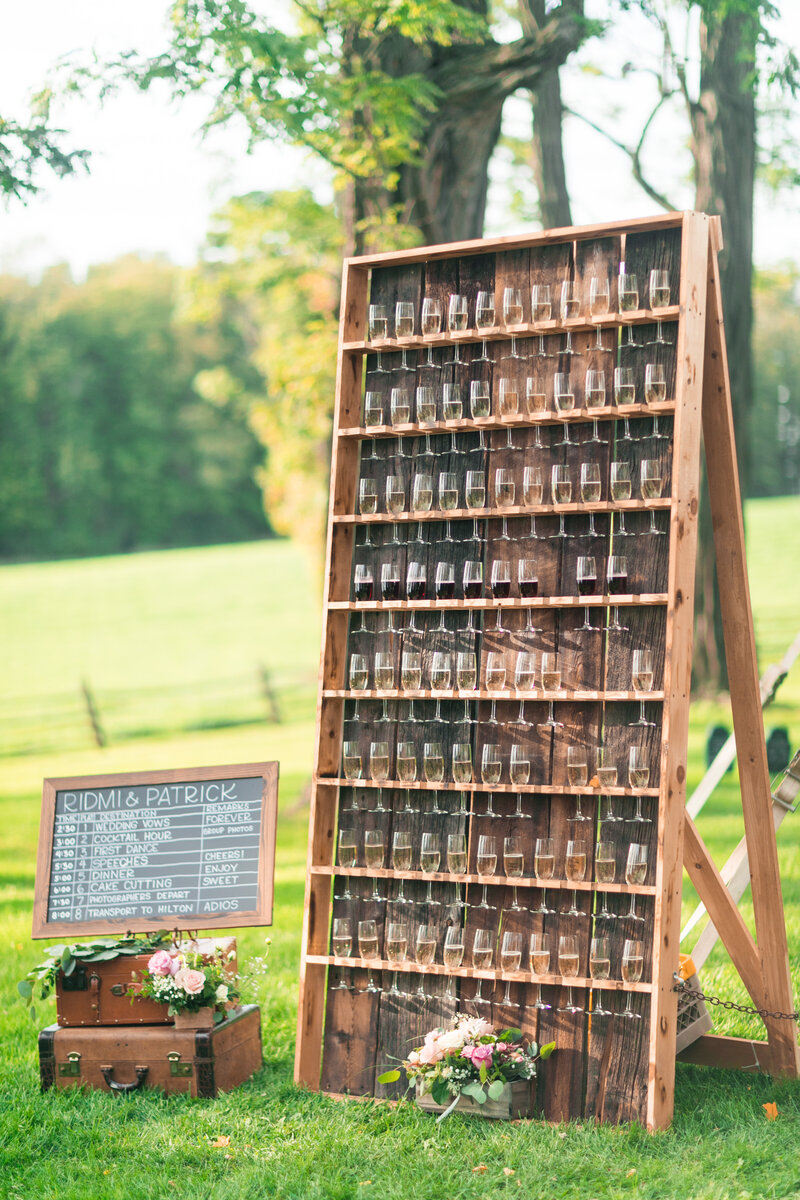 Large Champagne Welcome Wall in Vermont Wedding Photo Courtesy of Laura K Moore Photography