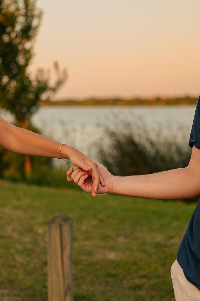 couple holding hands for engagement photos in dallas texas