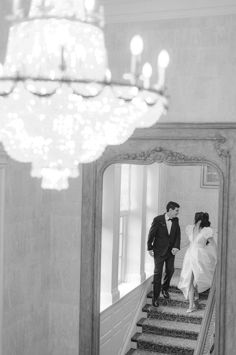 bride and groom facing each other drinking champagne