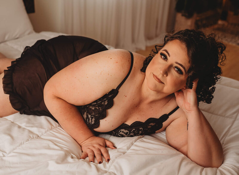 Woman in fishnets and crop top during boudoir photos