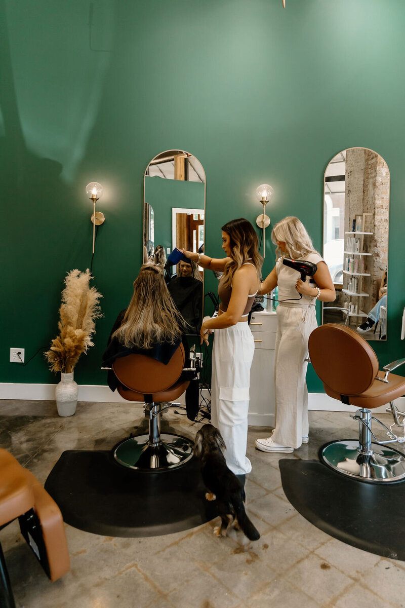 Group of talented hairstylists from The Vanity Hair Studio, Griffin, GA, specializing in haircuts, balayage, highlights, and Brazilian blowouts, creating a welcoming salon experience.