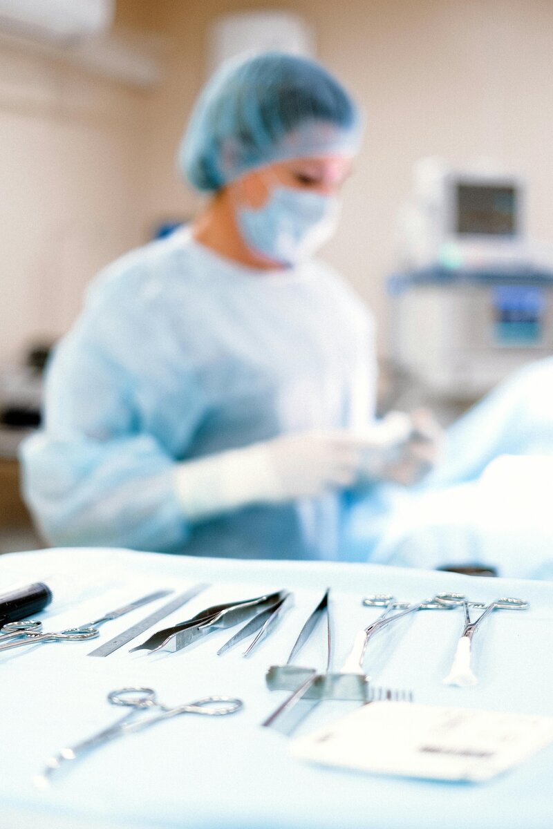 surgical tools with nurse in background