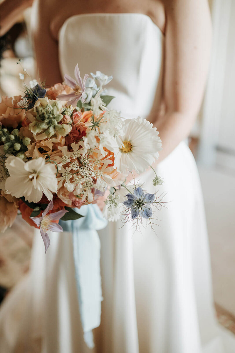Bride holding a bouquet of flowers at Dewsall Court