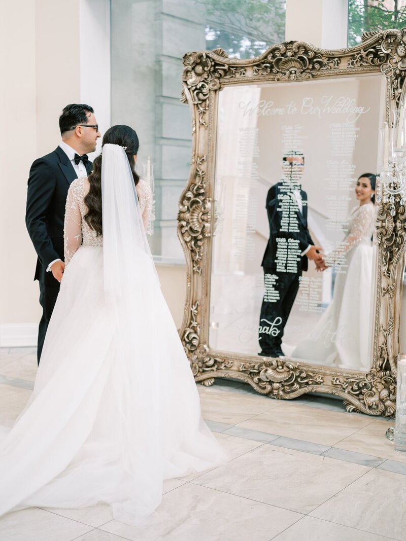 Newly weds embrace in front of a lovely historic venue.