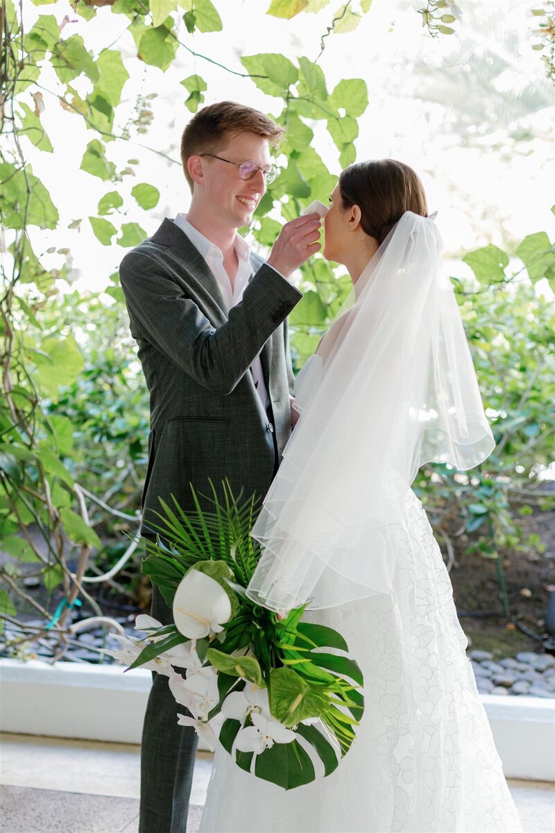 A person wiping their partner's tear on their wedding day 