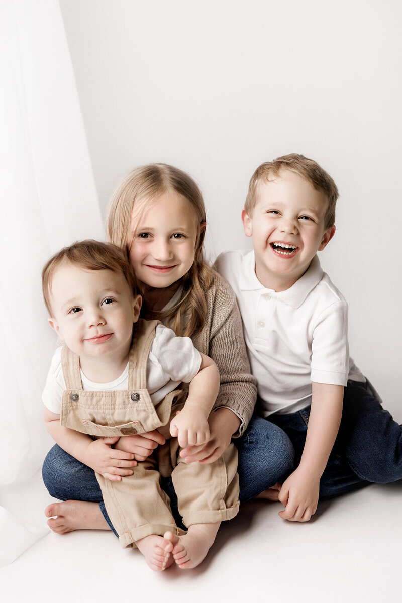  Image of 3 siblings hugging each other