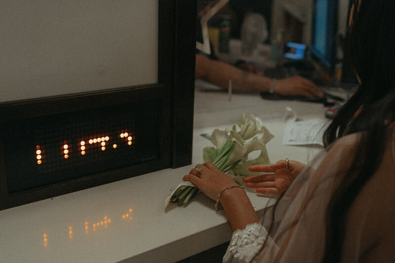 bride at city hall counter registering before eloping shot by Elsie Goodman Photography | NYC Elopement Packages
