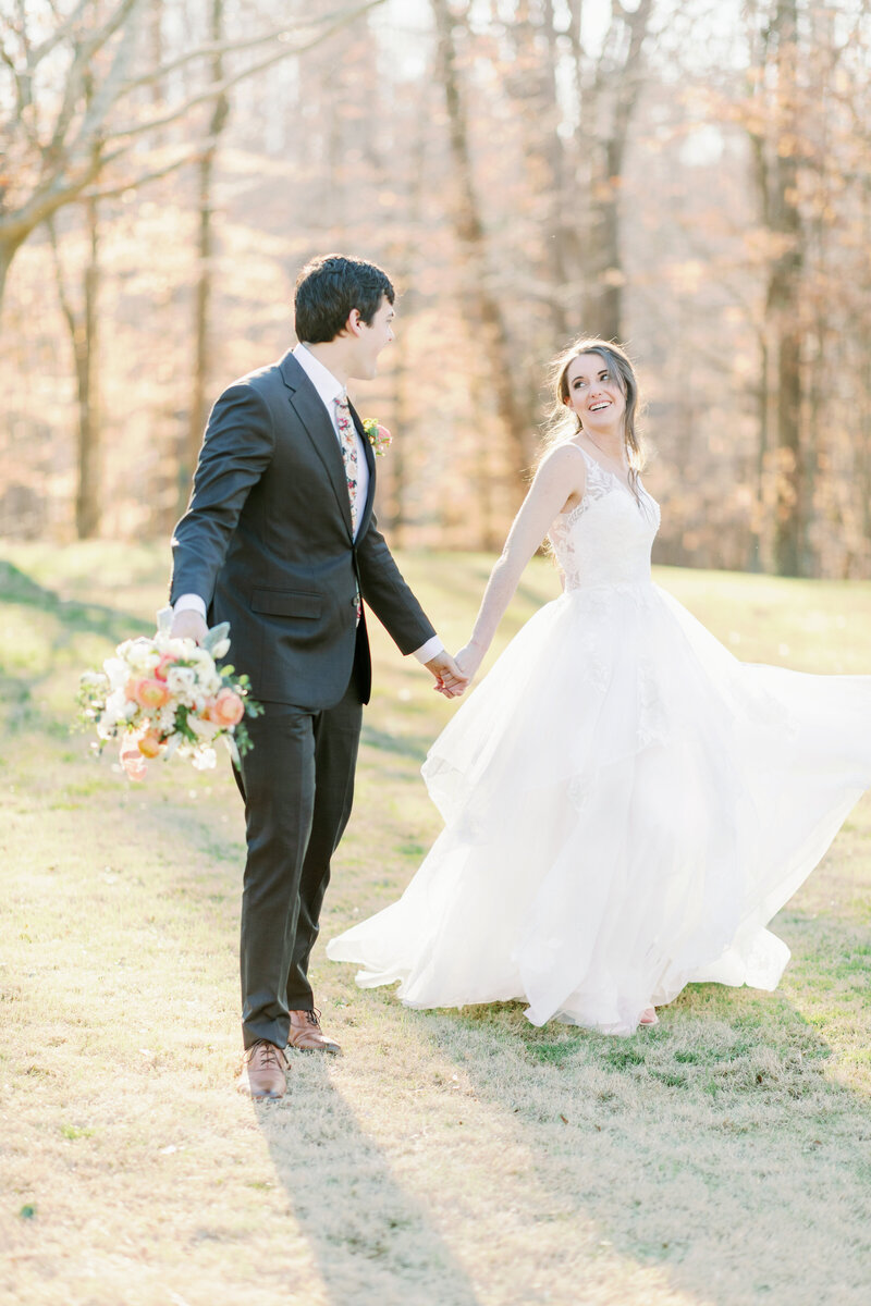 Bride and groom holding hands while running joyfully, embracing the excitement and energy of their wedding day in a beautifully captured moment.